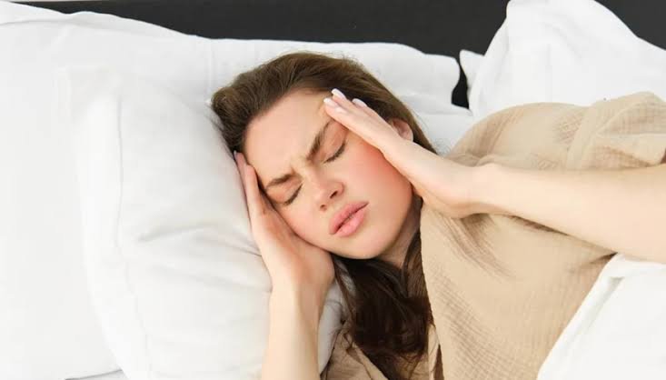 Illustrative photo of a person resting with a hand on their forehead